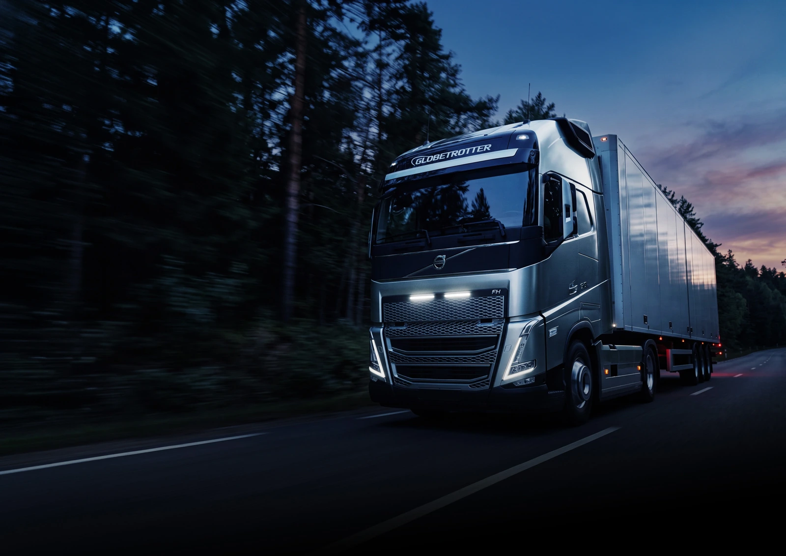 Volvo FH on a forest road at dusk