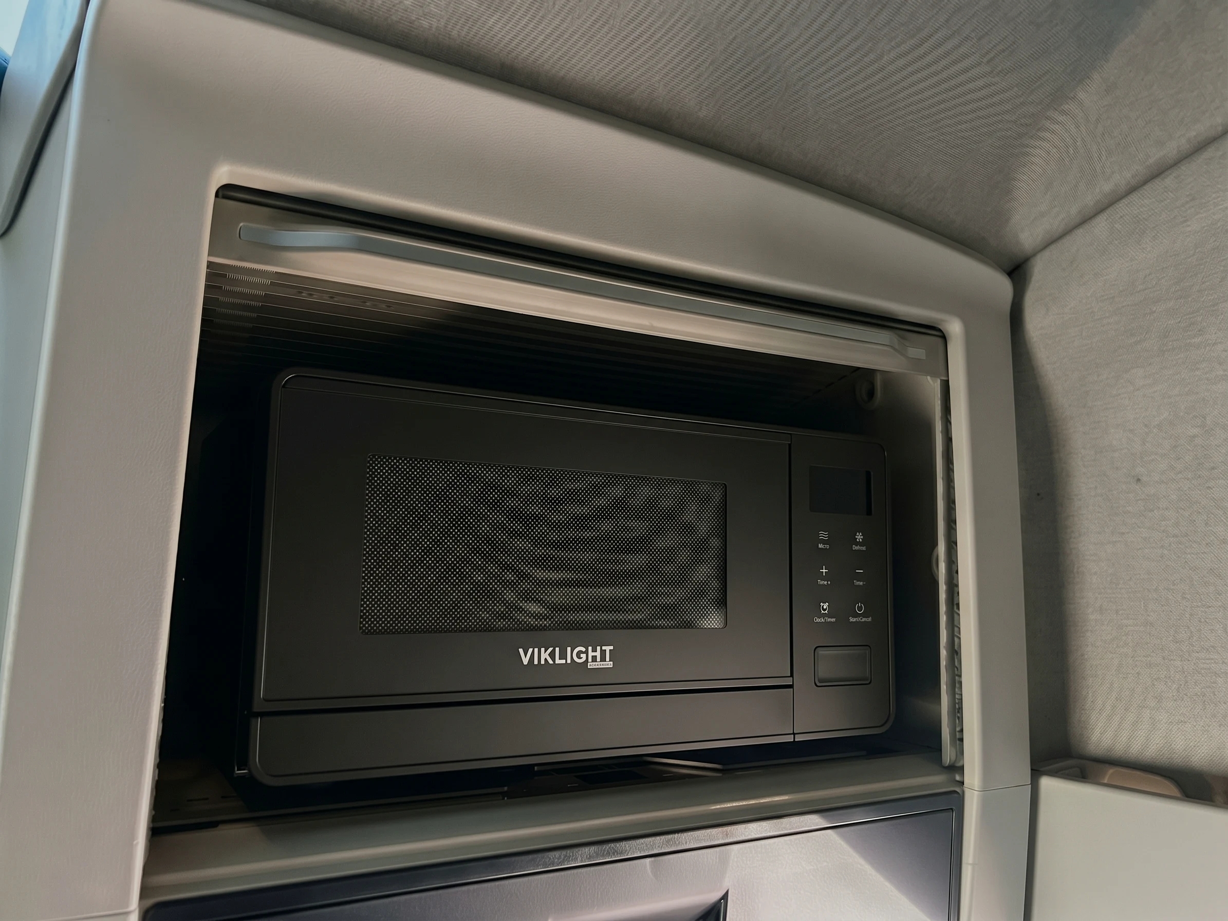 HEATi microwave fitted in the overhead compartment of a Volvo FH high cab